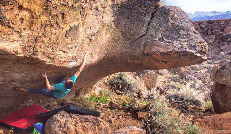 boulderer wearing scarpa instinct lace climbing shoes, climbing