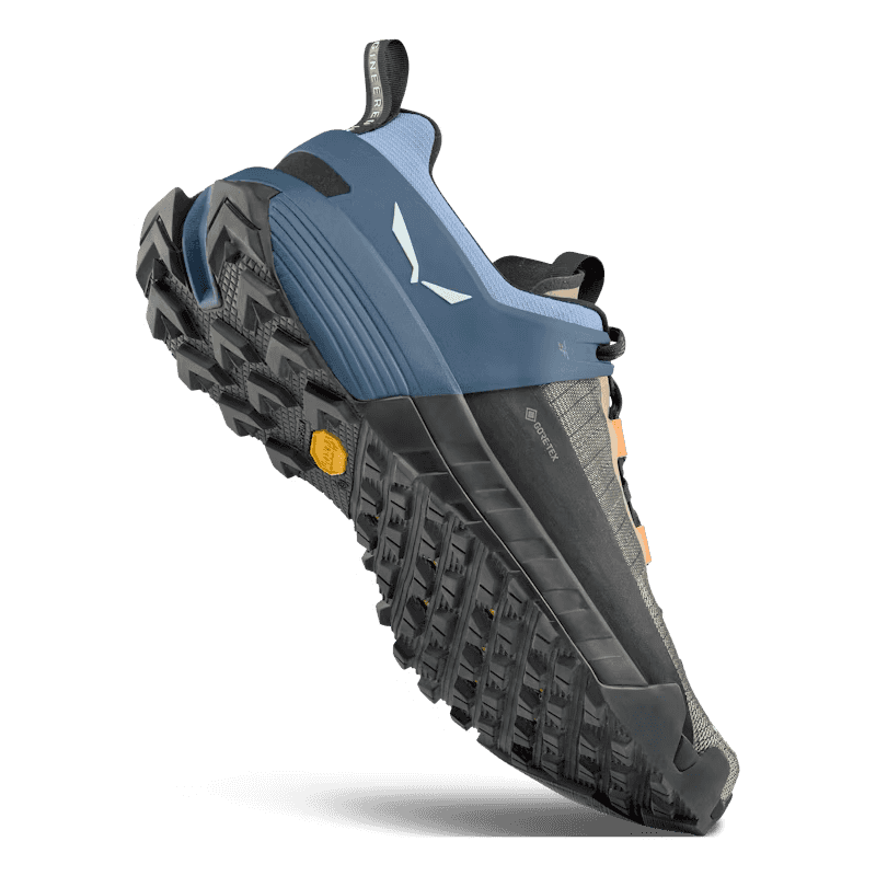 Blue athletic shoe with black sole on a white background
