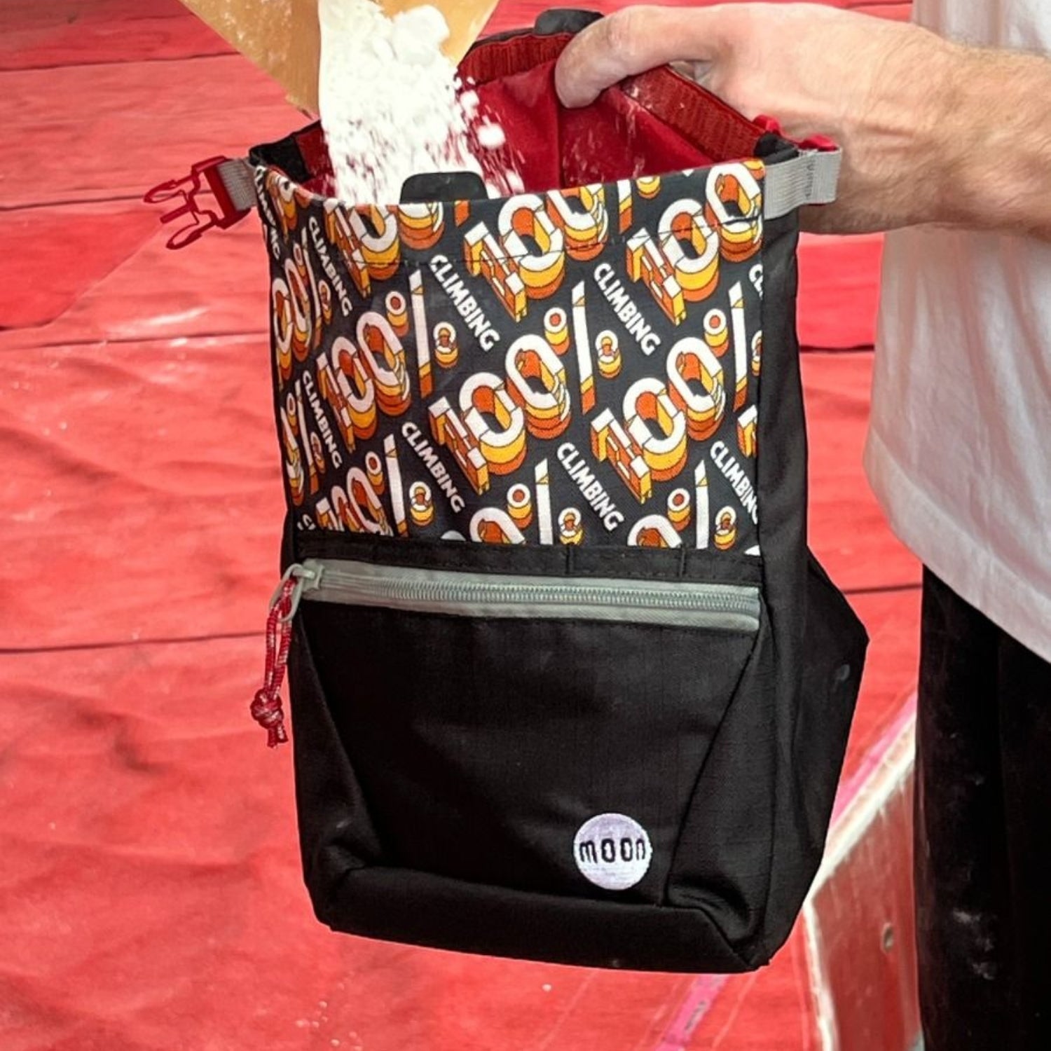 Black chalk bag with colourful patterned front section on a white background