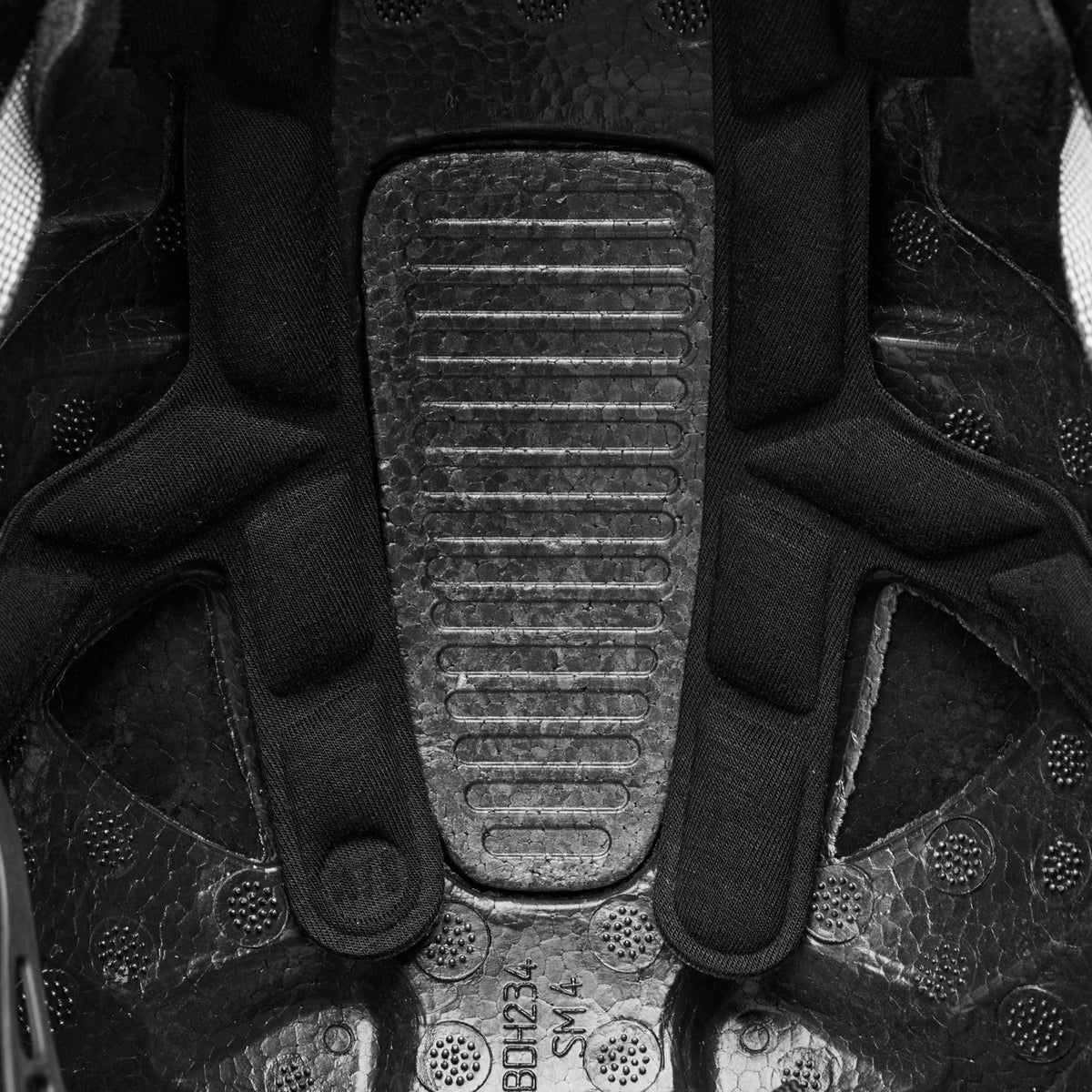 Close-up of a black boot sole with tread pattern and brand logo.