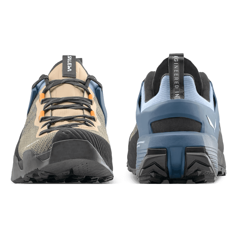 Two views of a hiking shoe with brand name on a clear background